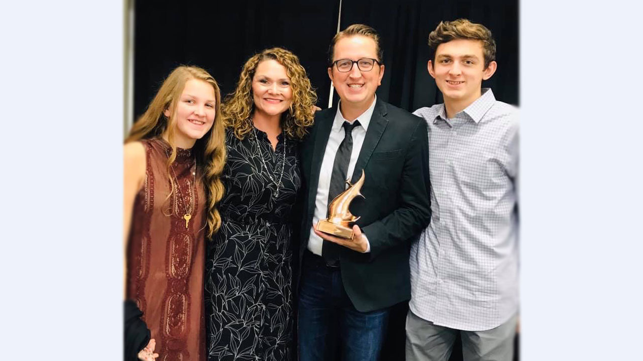 Woodstock First Baptist music minister Cliff Duren holds his Dove Award, standing with his wife, April, and two older children, 13-year-old Sidney and Mack, 14. Unable to make the trip to Nashville were the couple's nine-year-olds, Emma Kate and Elijah. Photo courtesy of Cliff Duren