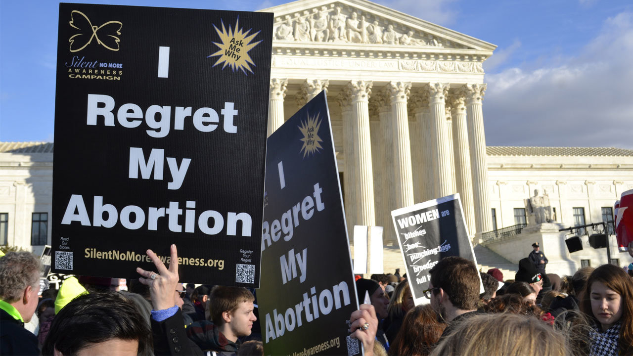 Women hold "I Regret My Abortion" signs at the U.S. Supreme Court in Washington D.C. on the annual March For Life Rally in 2015. GETTY IMAGES/Special