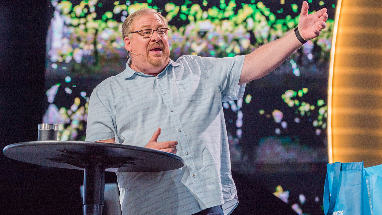 Pastor Rick Warren preaches during a February 2020 worship service at Saddleback Church. The church, celebrating its 40th anniversary this month, averages more than 30,000 attendees each weekend. SUMI SELLON/Saddleback Church