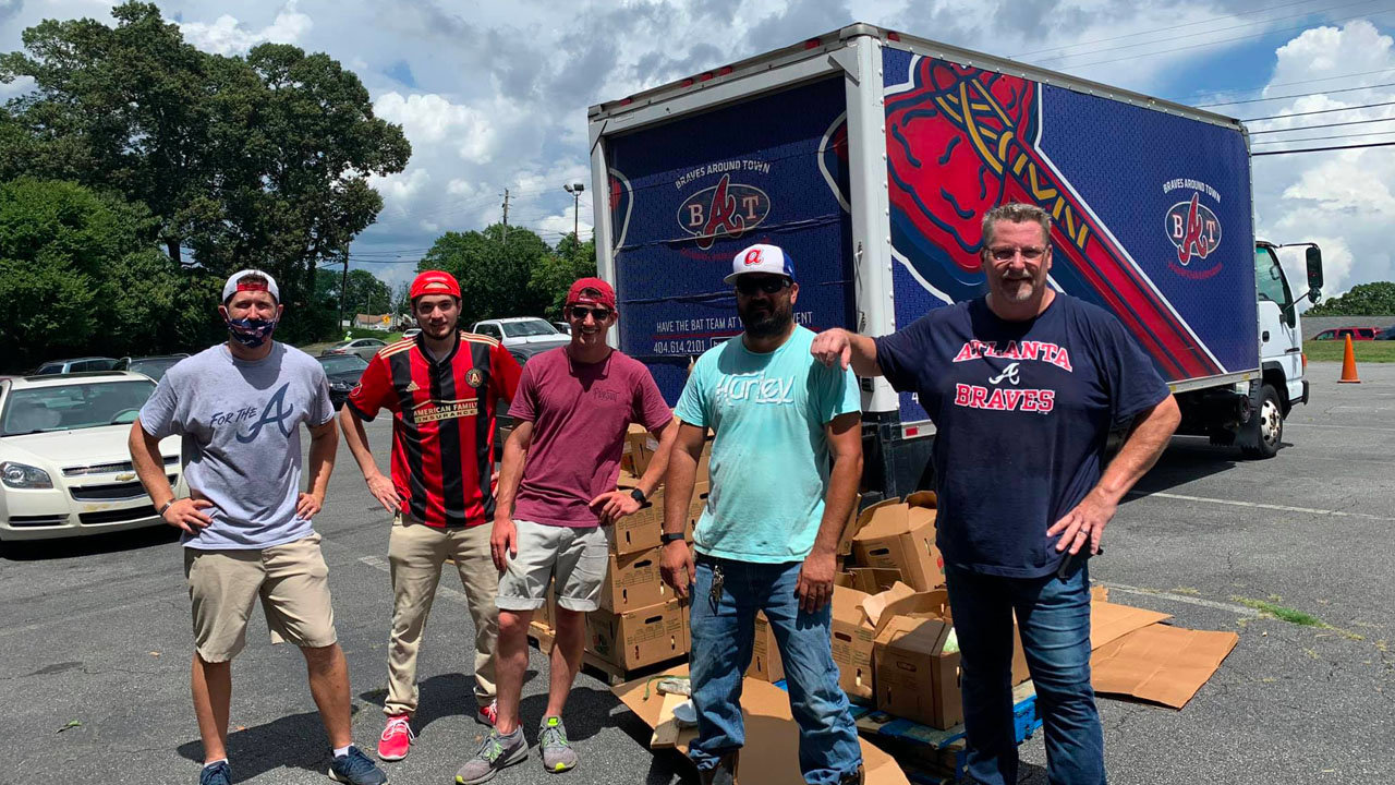At right Howard Koepka of Noonday Association of Churches stands with other volunteers while loading items kept in cold storage at Truist Park, home of the Atlanta Braves. Community partners have proven critical in Noonday's efforts to provide food through Storehouse Ministries. NOONDAY/Special