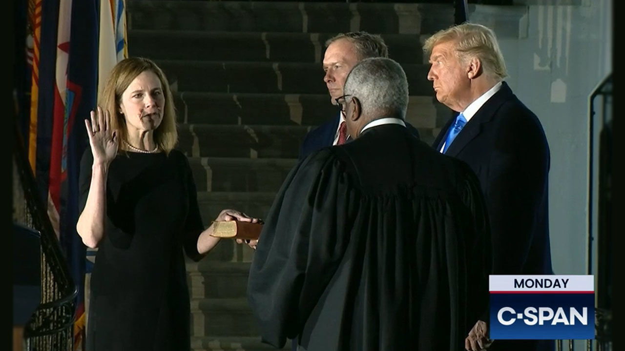 Amy Coney Barrett is sworn in as the 115th Supreme Court justice by Justice Clarence Thomas as President Donald Trump and Barrett's husband, Jesse, look on. Screen grab from c-span.org