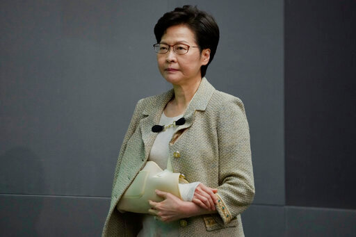 Hong Kong Chief Executive Carrie Lam wearing an arm brace after suffering fracture from fall at home, attends a press conference in Hong Kong, Tuesday, Oct. 26, 2021.  Lam said that under the city's Basic Law, the freedoms of association, assembly and speech are “guaranteed.” “No organization should be worried about legitimate operations in Hong Kong,” said Lam during a regular news conference Tuesday. “But it has to be done in accordance with the law.”(AP Photo/Kin Cheung)