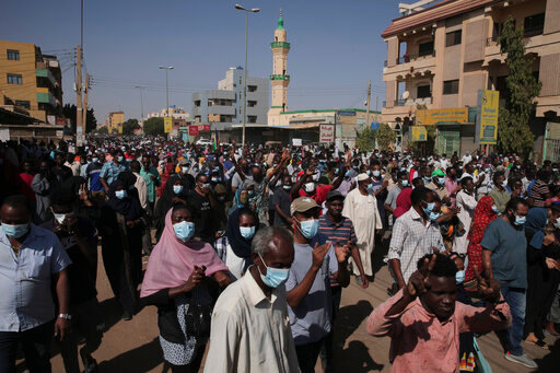 People protest in Khartoum, Sudan, Saturday, Nov. 13, 2021. Pro-democracy protesters took to the streets across Sudan to rally against the military's takeover last month. The rallies, called by the pro-democracy movement, came two days after the top general behind the coup reappointed himself head of the Sovereign Council, Sudan's interim governing body. (AP Photo/Marwan Ali)