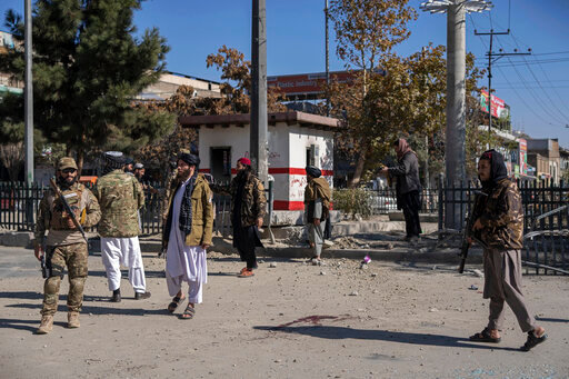 Taliban fighters secure the area after a roadside bomb went off in Kabul Afghanistan, Monday Nov. 15, 2021. The bomb exploded on a busy avenue in the Afghan capital on Monday, wounding two people, police said. (AP Photo/ Petros Giannakouris)