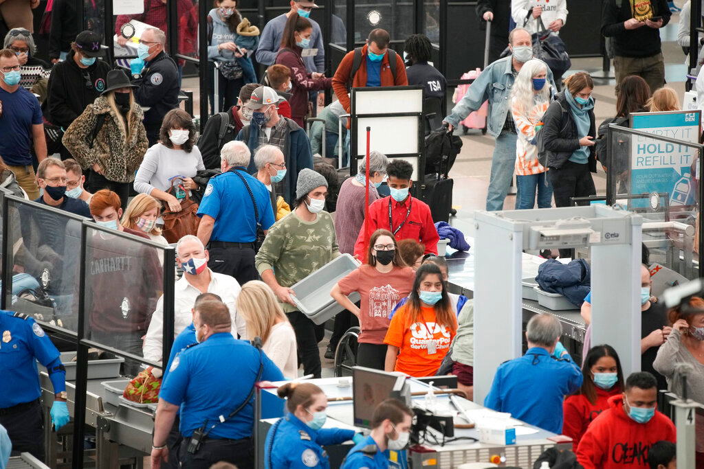 Travellers queue up at the south security checkpoint as traffic increases with the approach of the Thanksgiving Day holiday Tuesday, Nov. 23, 2021, at Denver International Airport in Denver. (AP Photo/David Zalubowski)...........