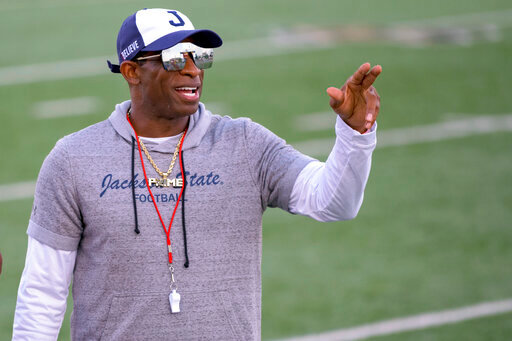 FILE - Jackson State head coach Deion Sanders points during an NCAA football game against Louisiana Monroe on Saturday, Sept. 18, 2021, in Monroe, La. Deion Sanders has been all over national TV, putting Jackson State in the spotlight every time his insurance commercials air. Hiring Eddie George has had a similar effect at Tennessee State.  (AP Photo/Matthew Hinton, File)