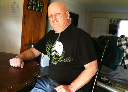 Howard Breidenbach recuperates at his home in Myrtle Creek, Ore., on Tuesday Nov. 23, 2021. The 47-year-old independent trucker survived a long-term bout with COVID-19. (Michael Sullivan/The News-Review via AP)
