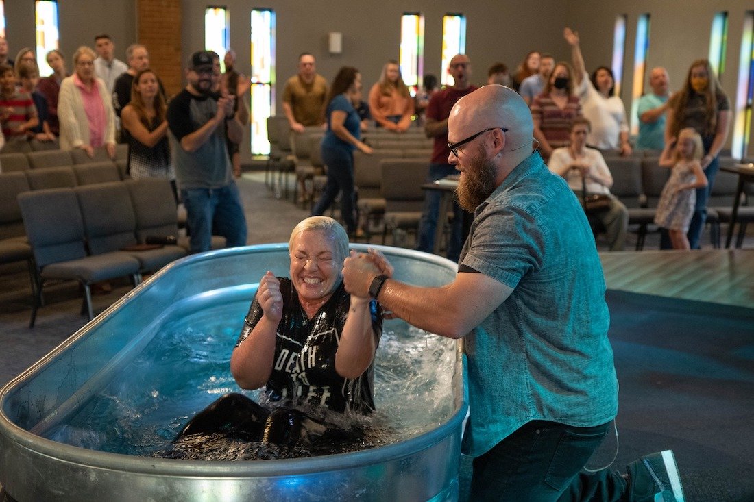 Noah Oldham baptizes a believer during a church service at August Gate Church in St. Louis where Oldham serves as pastor. Oldham is also the senior director of church planter deployment for Send Network at the North American Mission Board. (August Gate photo)