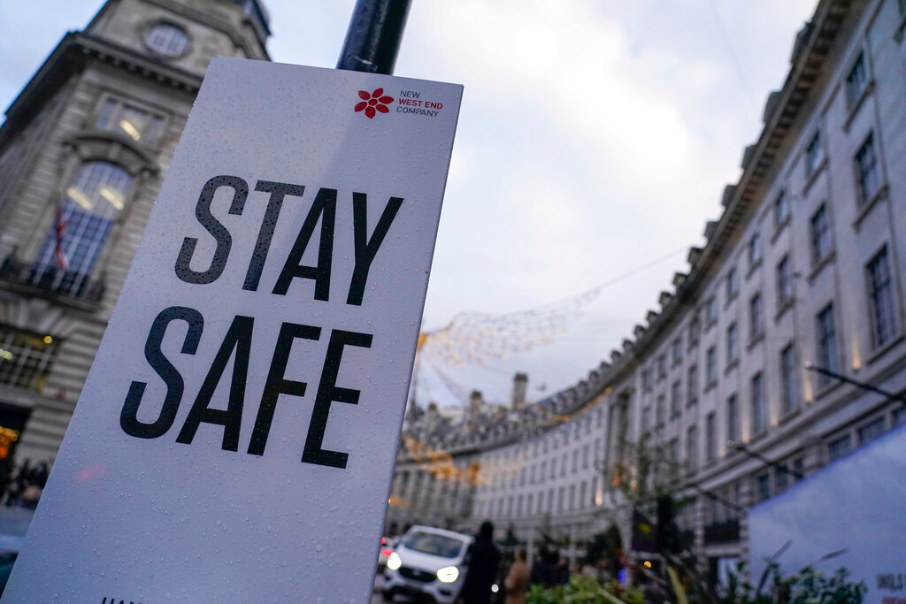 A sign reading ’Stay safe’ in Regent Street, in London, Friday, Nov. 26, 2021. A slew of nations moved to stop air travel from southern Africa on Friday, and stocks plunged in Asia and Europe in reaction to news of a new, potentially more transmissible COVID-19 variant.(AP Photo/Alberto Pezzali)