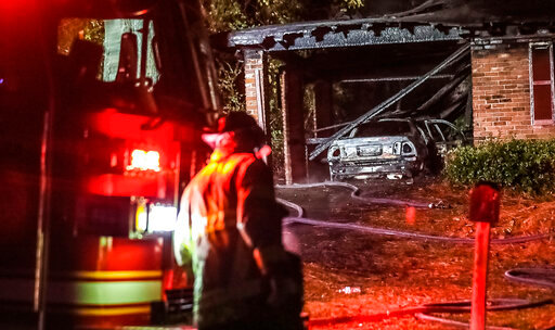 Firefighters respond to a house fire early Tuesday, Dec. 14, 2021 in DeKalb County, Ga. DeKalb County fire Capt. Jaeson Daniels says the deadly blaze began early Tuesday in the county just east of Atlanta. (John Spink /Atlanta Journal-Constitution via AP)