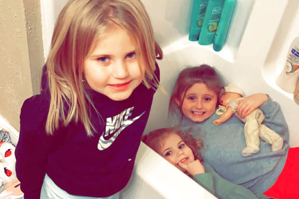 In this Dec. 10, 2021, photo provided by Sandra Hooker, shows from left, Avalinn Rackley, 7, Alanna Rackley, 3, and Annistyn Rackley, 9 in their home near Caruthersville, Missouri. Annistyn, a third-grader who loved swimming, dancing and cheerleading, was among dozens of people who died because of Friday night's storm. A tornado hit her home and splintered it less than a week after the family had moved in, and, according to the relative who received the photo of the girl in the bathtub, it carried family members dozens of yards before dropping them in a muddy field. (Meghan Rackley via AP)