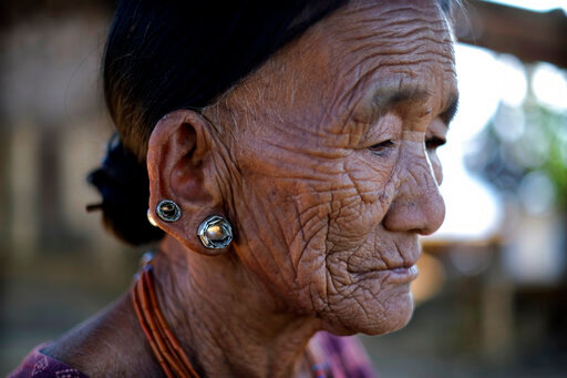 Nguntoi Konyak, 85,  sits outside her home in Oting village, in the northeastern Indian state of Nagaland, Thursday, Dec. 16, 2021. "They killed innocent villagers. All the young boys of this village have been killed," Nguntoi said. High up in the hills along India's border with Myanmar, Oting village is in mourning after more than a dozen people from the village were killed by Indian army soldiers. (AP Photo/Yirmiyan Arthur)