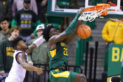 Baylor forward Jonathan Tchamwa Tchatchoua (23) dunks over Alcorn State guard Paul King in the second half of an NCAA college basketball game, Monday, Dec. 20, 2021, in Waco, Texas. (AP Photo/Rod Aydelotte)