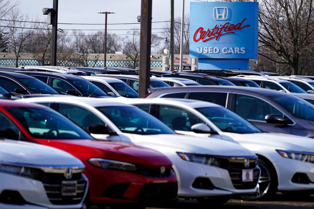 A dealership sign is seen outside of Honda certified used car dealership in Schaumburg, Ill., Thursday, Dec. 16, 2021.  Prices for used cars have soared so high, so fast, that buyers are being increasingly priced out of the market. (AP Photo/Nam Y. Huh)