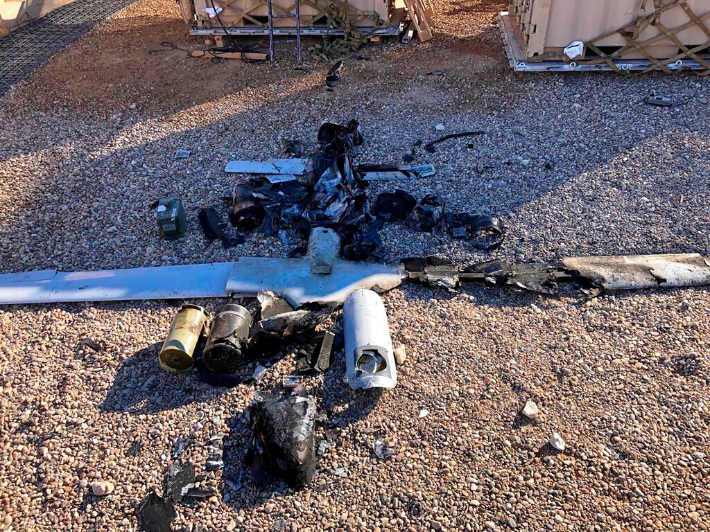Parts of the wreckage of a drone lie on the ground near the Ain al-Asad airbase in the western Anbar province, Iraq, Tuesday, Jan. 4, 2022. Two explosives-laden drones targeting the base housing U.S. troops were engaged and destroyed by defensive capabilities at the base on Tuesday, a coalition official said. (International Coalition via AP)