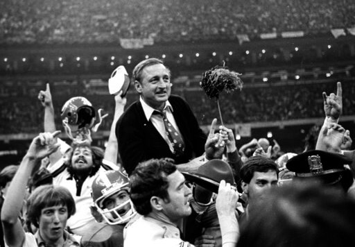 Georgia football coach Vince Dooley is carried off the field after Georgia defeated Notre Dame 17-10 in the Sugar Bowl college football game Jan. 1, 1981, in New Orleans. Dooley loves history _ especially the kind he says favors his beloved Bulldogs. Dooley believes a rematch will work in Georgia's advantage against Alabama in the College Football Playoff title game on Monday night in Indianapolis. Dooley also has faith Georgia's defense will fare better in its second chance against Alabama quarterback Bryce Young. (AP Photo/Gene Blythe, File)