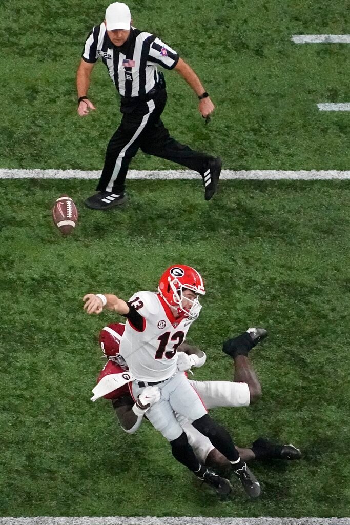 Alabama's Christian Harris forces a fumble on Georgia's Stetson Bennett during the second half of the College Football Playoff championship football game Monday, Jan. 10, 2022, in Indianapolis. (AP Photo/Charlie Riedel)