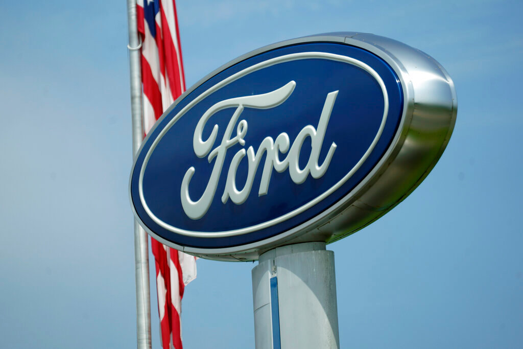 A Ford logo is seen on signage at Country Ford in Graham, N.C., Tuesday, July 27, 2021. (AP Photo/Gerry Broome)
