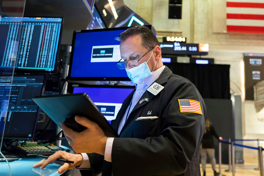 In this photo provided by the New York Stock Exchange, trader Edward Curran works on the floor, Monday, Jan. 24, 2022. The Dow Jones Industrial Average dropped more than 1,000 points Monday as financial markets buckled in anticipation of inflation-fighting measures from the Federal Reserve and fretted over the possibility of conflict between Russia and Ukraine. (Courtney Crow/New York Stock Exchange via AP)