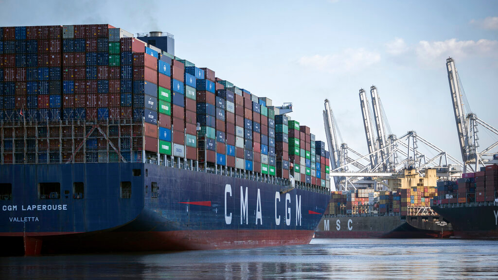 The container ship CMA CGM Laperouse, left, docks at the Georgia Ports Authority's Port of Savannah, Sept. 29, 2021, in Savannah, Ga. The Port of Savannah saw a whopping 20% increase in shipping containers moving across its docks in 2021 as U.S. seaports scrambled to keep up with a surge in cargo that crammed container yards and forced ships to line up and wait at sea. The Georgia Ports Authority reported Tuesday, Jan. 25, 2022 that Savannah's port handled a record 5.6 million container units of imports and exports last year _ an increase of 1 million container units from the 2020 calendar year. (AP Photo/Stephen B. Morton, file)
