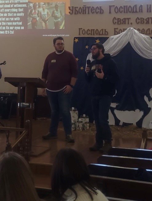 Jaxson Wood and Matthew Wacter, two of the three past presidents of the Columbus State University Baptist Collegiate Ministry who took the mission trip, speak to Ukrainian believers.