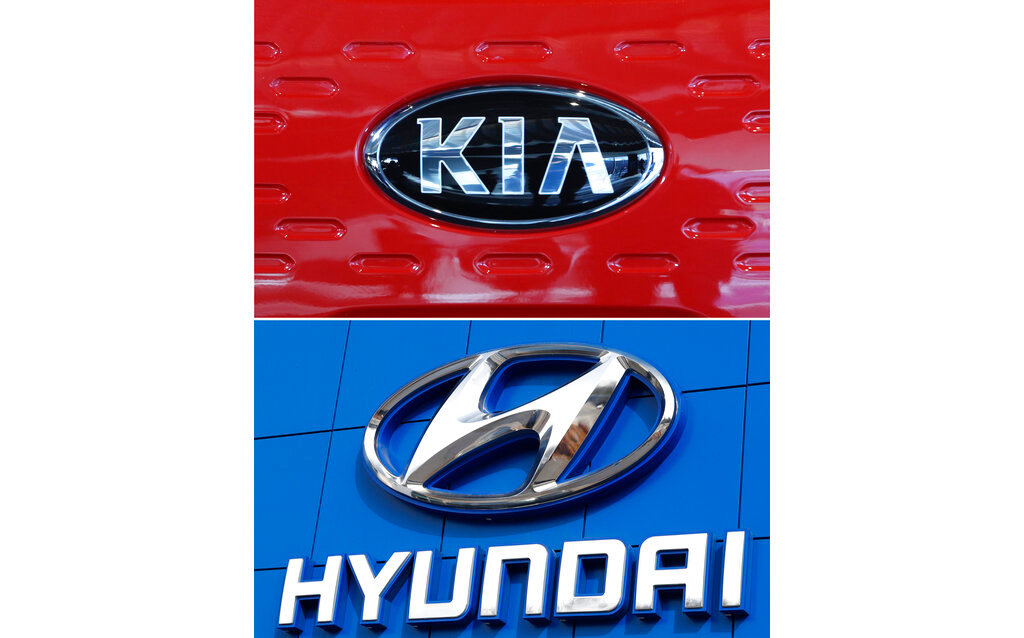 This combination of file photos shows the logo of Kia Motors during an unveiling ceremony on Dec. 13, 2017, in Seoul, South Korea, top, and Hyundai logo on the side of a showroom on April 15, 2018, in the south Denver suburb of Littleton, Colo., bottom. Hyundai and Kia are recalling more than a half million vehicles in the U.S. because of new problems that can lead to engine fires. Documents posted Thursday, Feb. 28, 2019, by the government show the Korean automakers are adding three recalls after reports of fires across the country. (AP Photo, File)