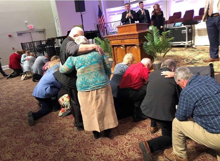 People respond to an altar call at a recent revival service.