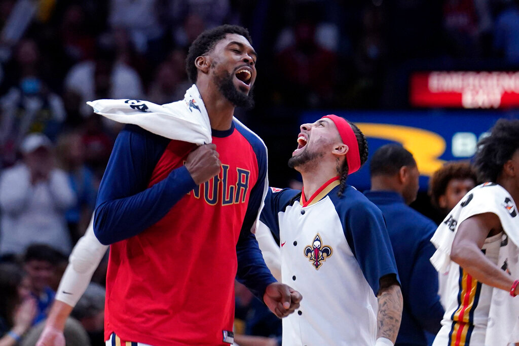 New Orleans Pelicans forward Naji Marshall, left, and guard Jose Alvarado celebrate as a timeout is called in the second half of an NBA basketball game against the Los Angeles Lakers in New Orleans, Sunday, March 27, 2022. The Pelicans won 116-108. (AP Photo/Gerald Herbert)