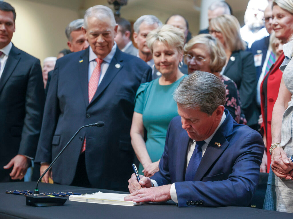 With much fanfare, Gov. Brian Kemp signs HB 1013, which aims to increase access to mental health coverage in Georgia on Sine Die, the last day of the General Assembly at the Georgia State Capitol in Atlanta on Monday, April 4, 2022.   (Bob Andres / robert.andres@ajc.com)