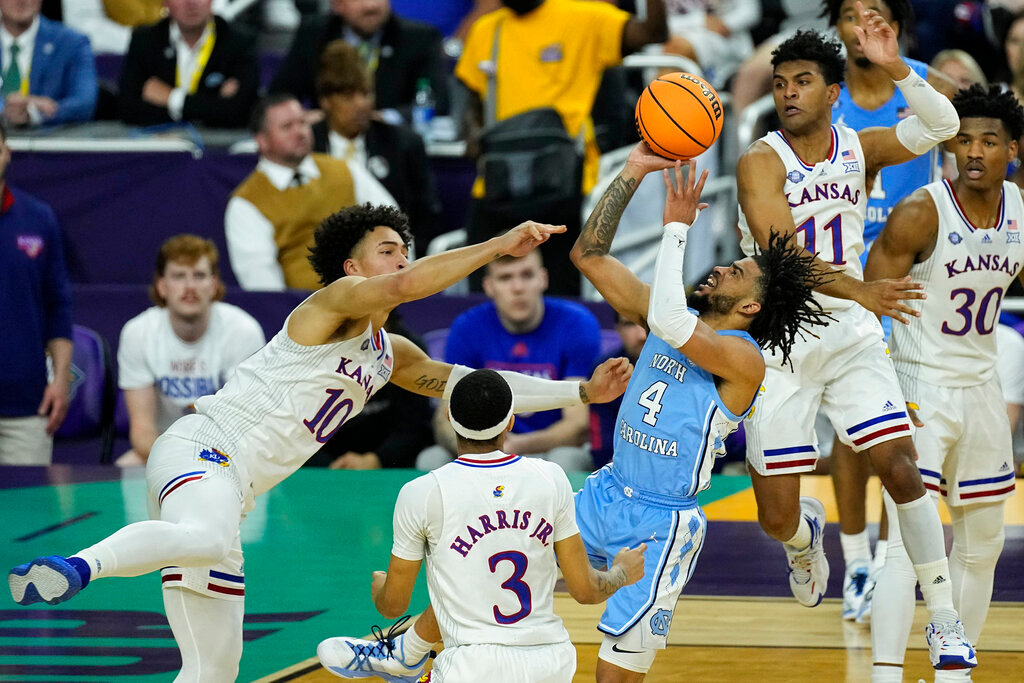 North Carolina guard R.J. Davis (4) shoots against Kansas forward Jalen Wilson (10) during the first half of a college basketball game in the finals of the Men's Final Four NCAA tournament, Monday, April 4, 2022, in New Orleans. (AP Photo/Gerald Herbert)
