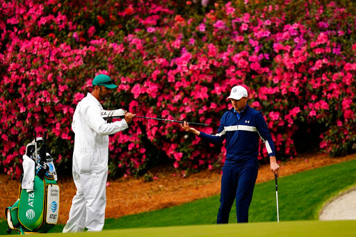 Jordan Spieth gets a club from his caddie on the 13th hole during a practice round for the Masters golf tournament on Tuesday, April 5, 2022, in Augusta, Ga. (AP Photo/Matt Slocum)