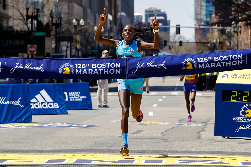 Peres Jepchirchir, of Kenya, crosses the finish line to win the women's division of the 126th Boston Marathon, Monday, April 18, 2022, in Boston. (AP Photo/Winslow Townson)