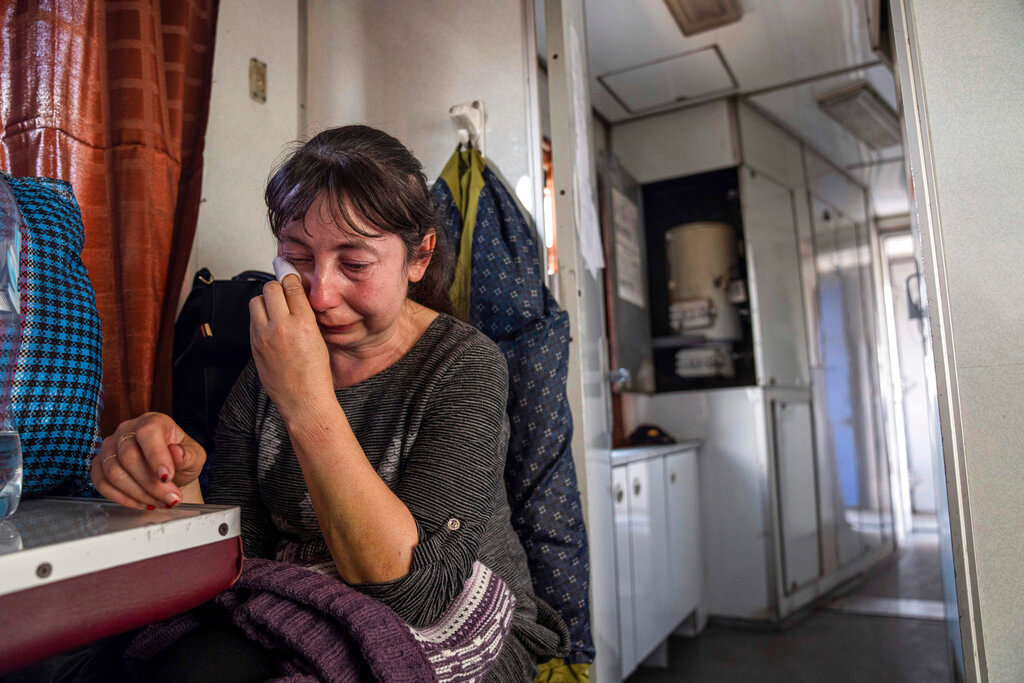 A woman from Luhansk region cries while sitting on the evacuation train in Pokrovsk, eastern Ukraine, Tuesday, April 26, 2022. (AP Photo/Evgeniy Maloletka)