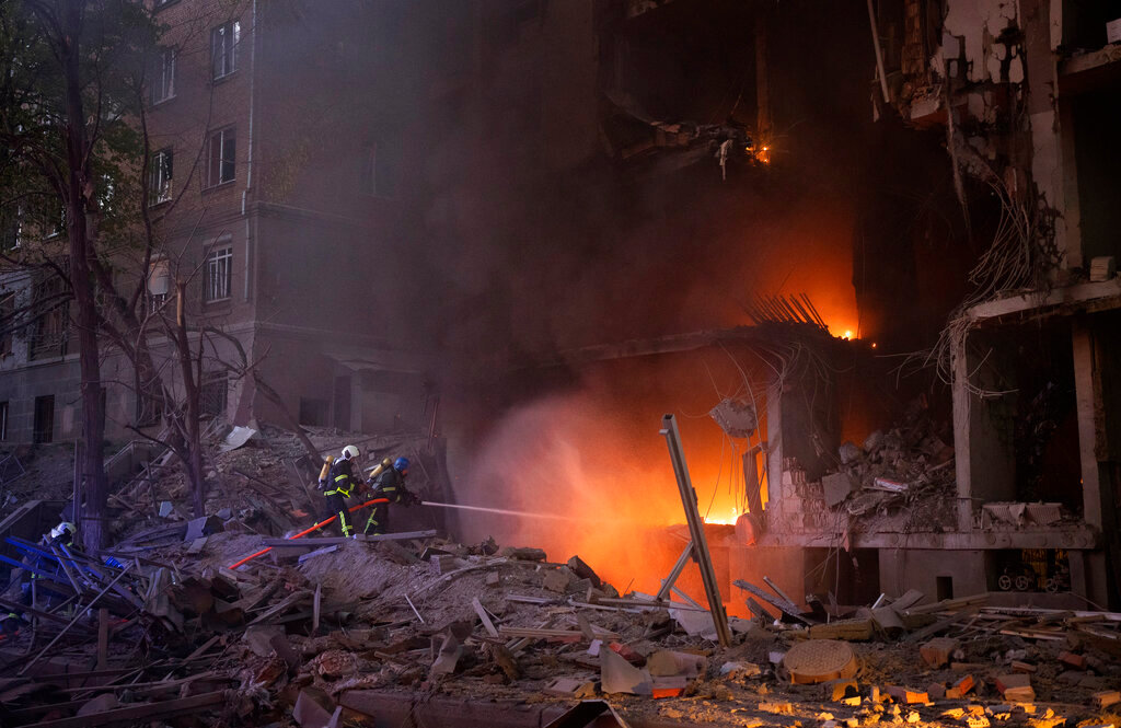 Firefighters try to put out a fire following an explosion in Kyiv, Ukraine on Thursday, April 28, 2022. Russia mounted attacks across a wide area of Ukraine on Thursday, bombarding Kyiv during a visit by the head of the United Nations. (AP Photo/Emilio Morenatti)