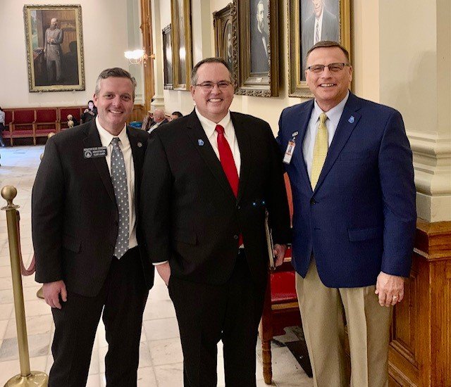 Homerville First Baptist Pastor Paul Fulton, state Sen. Russ Goodman, and Public Affairs Representative Mike Griffin pose for a photo in the Capitol.