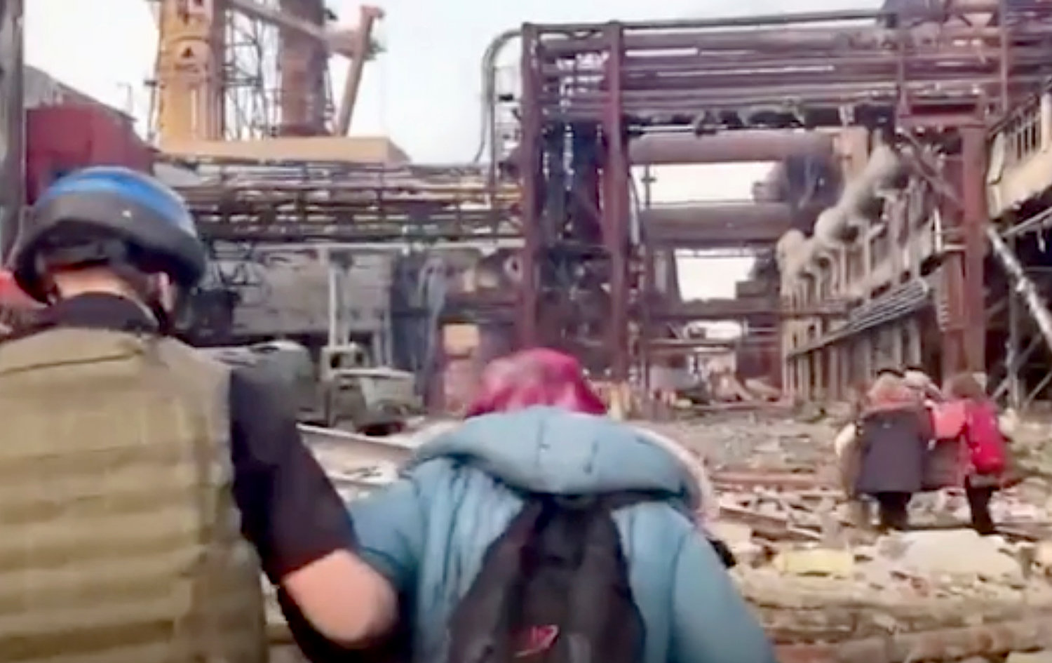 This frame taken from an undated video provided Sunday, May 1, 2022 by the Azov Special Forces Regiment of the Ukrainian National Guard shows people walking over debris at the Azovstal steel plant, in Mariupol, eastern Ukraine. (Azov Special Forces Regiment of the Ukrainian National Guard via AP)