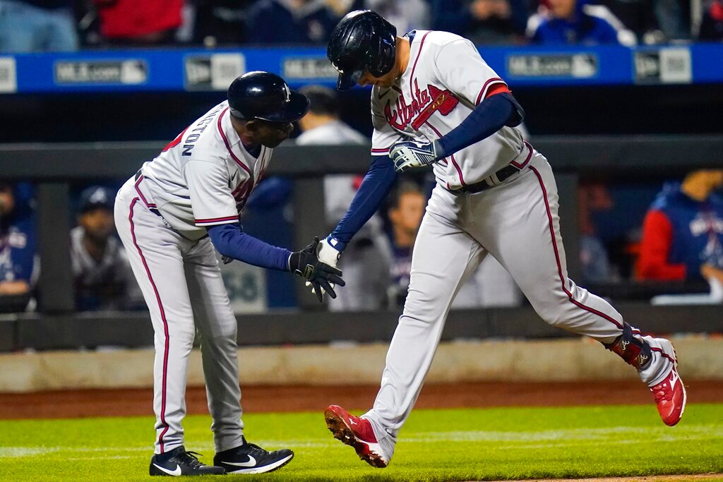Atlanta Braves' Austin Riley, right, celebrates with third base coach Ron Washington as he runs the bases after hitting a home run during the fourth inning of a baseball game against the New York Mets, Monday, May 2, 2022, in New York. (AP Photo/Frank Franklin II)