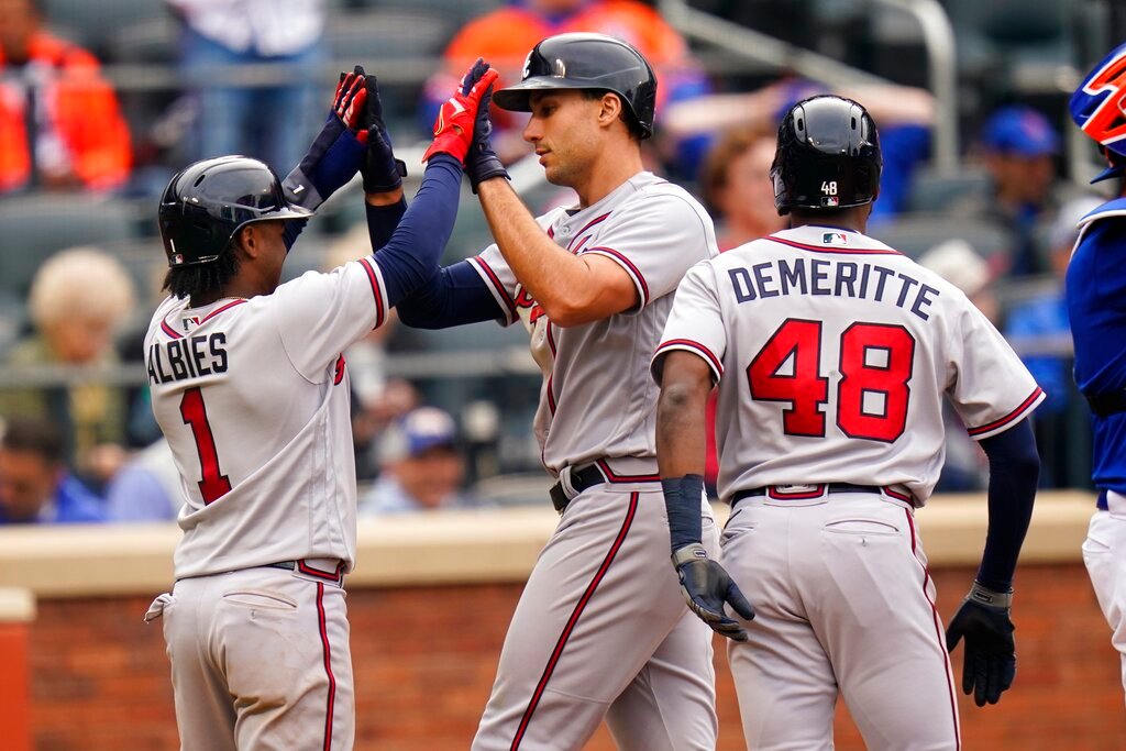 Atlanta Braves' Matt Olson, center, celebrates with Ozzie Albies, left, and Travis Demeritte, right, after Olson hit a three-run home run during the fifth inning in the first game of a doubleheader against the New York Mets, Tuesday, May 3, 2022, in New York. (AP Photo/Frank Franklin II)