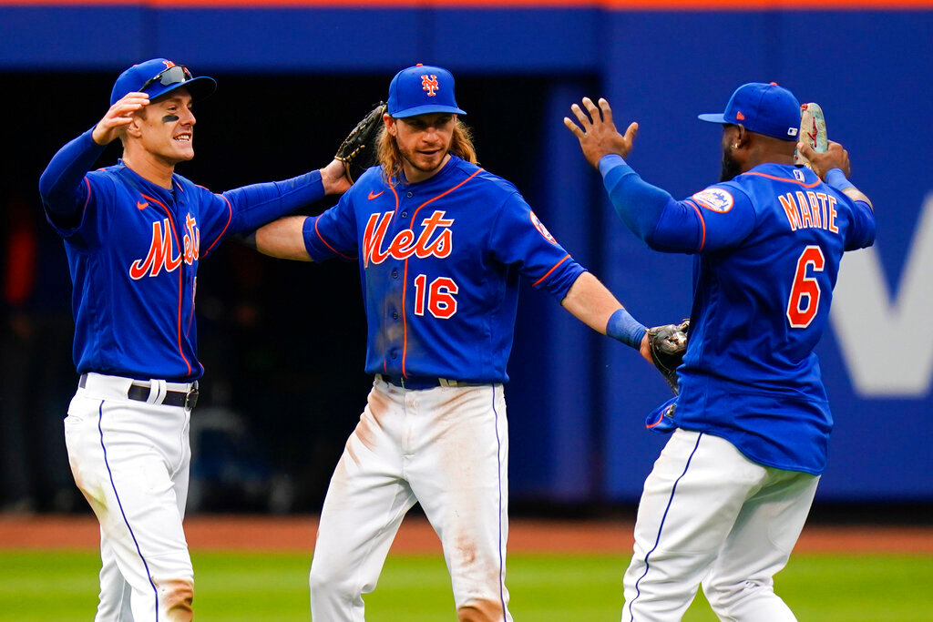 New York Mets players, from left, Mark Canha, Travis Jankowski and Starling Marte celebrate after defeating the Atlanta Braves in the the first game of a doubleheader, Tuesday, May 3, 2022, in New York. The Mets won 5-4. (AP Photo/Frank Franklin II)