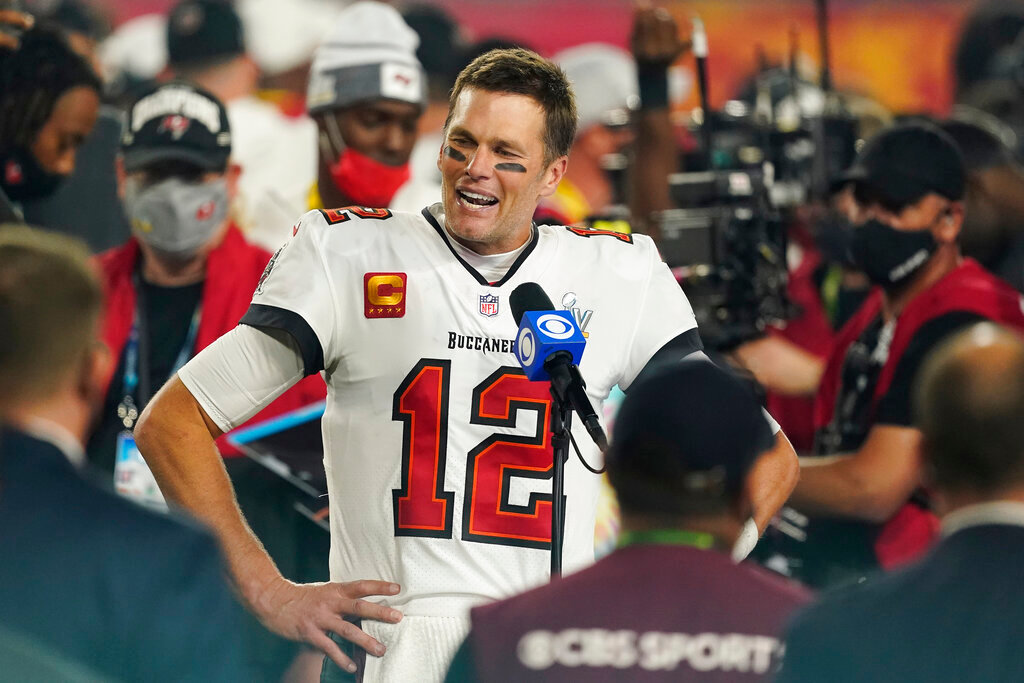 Tampa Bay Buccaneers quarterback Tom Brady speaks to reporters on the field after Super Bowl LV against the Kansas City Chiefs, in Tampa, Fla., Sunday, Feb. 7, 2021. The first 2022 regular-season NFL game in Germany will be between the Tampa Bay Buccaneers and the Seattle Seahawks at the home of soccer club Bayern Munich. Brady, who won two games with the New England Patriots in London and another in Mexico City, could become the first quarterback to start a game in three foreign countries. (AP Photo/Steve Luciano, File)