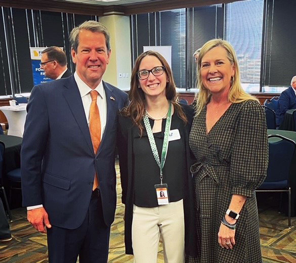 Georgia Gov. Brian Kemp and his wife Marty pose with Elizabeth Reed, center, at the Capitol in February.