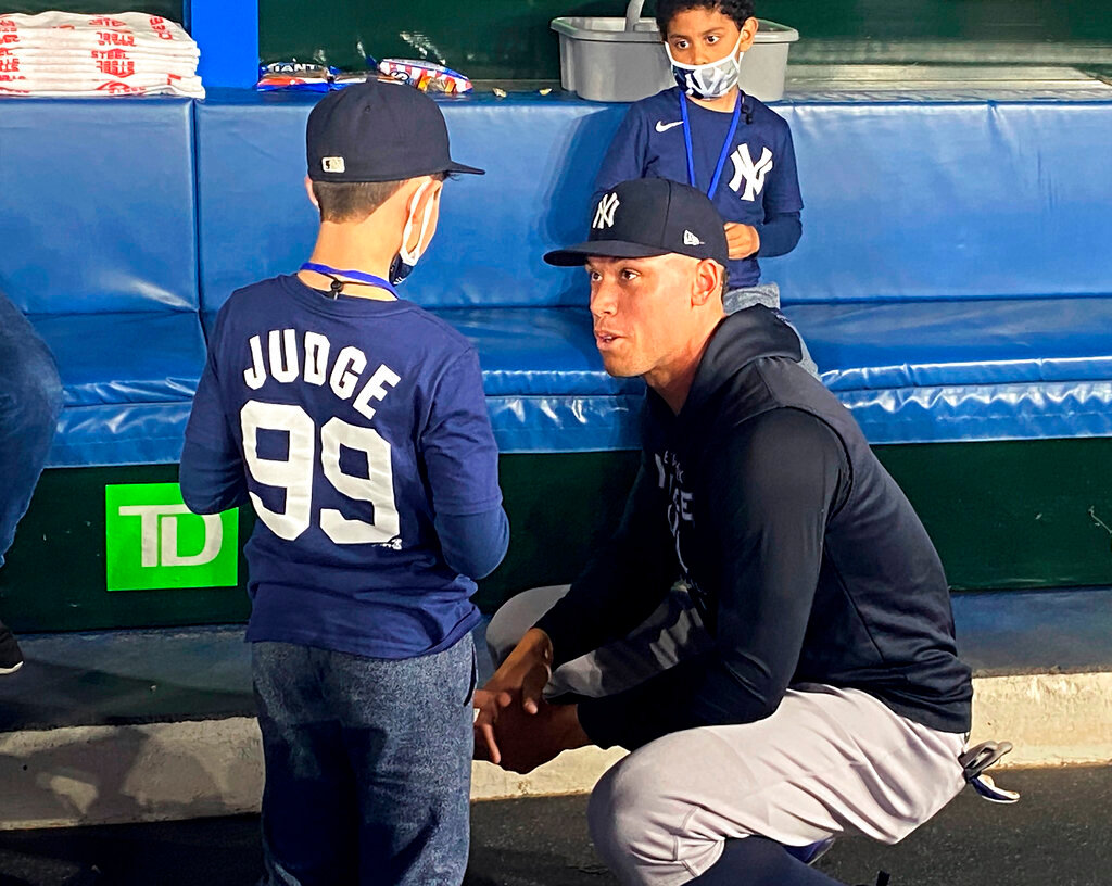 Nine-year-old Derek Rodriguez meets Yankees slugger Aaron Judge in the New York dugout on Wednesday afternoon  before the start of game against the Toronto Blue Jays in Toront, Wednesday, May 4, 2022. The young New York Yankees fan's dreams came true on Tuesday night in Toronto when he was handed a home-run ball hit by Aaron Judge. (Photo/Gregory Strong, Canadian Press via AP)
