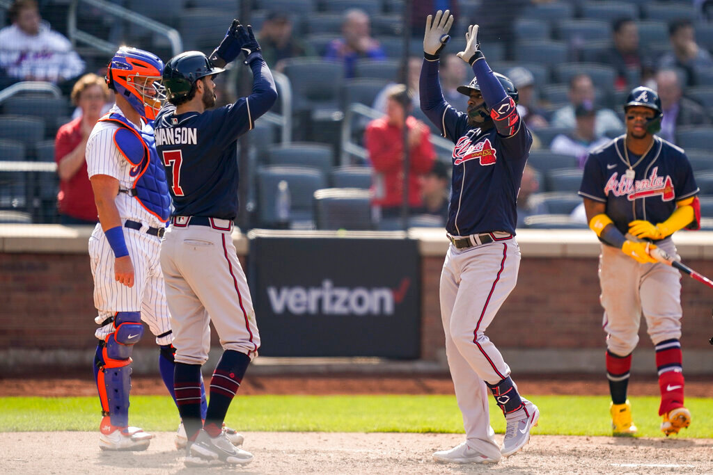 Atlanta Braves' Guillermo Heredia, right, celebrates with Dansby Swanson (7) after hitting a two-run home run off New York Mets starting pitcher Trevor Williams (29) in the eighth inning Wednesday, May 4, 2022, in New York. (AP Photo/John Minchillo)