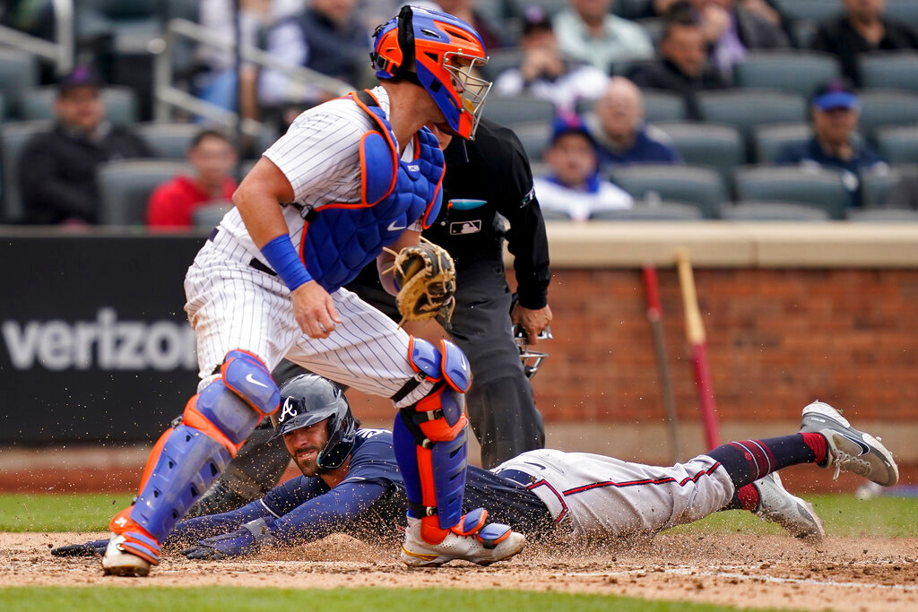 Atlanta Braves' Dansby Swanson scores on an RBI single hit by Ronald Acuna Jr. off New York Mets relief pitcher Trevor Williams in the sixth inning Wednesday, May 4, 2022, in New York. (AP Photo/John Minchillo)