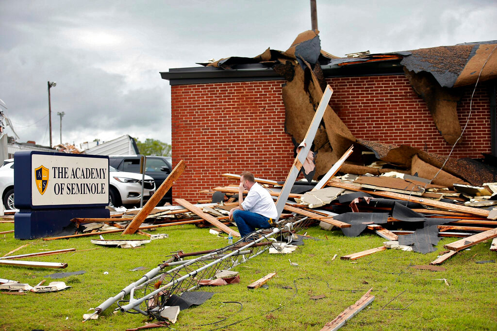 Paul Campbell, founder of the Academy of Seminole sits outside the tornado-damaged school in Seminole, Okla., Thursday, May, 5, 2022. A springtime storm system spawned several tornadoes that whipped through areas of Texas and Oklahoma, causing damage to a school, a marijuana farm and other structures. (Photo/Sarah Phipps, The Oklahoman via AP)