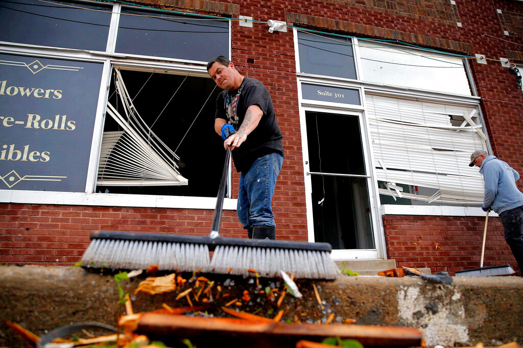 William Hawkins cleans up tornado damage in Seminole, Okla, Thursday, May, 5, 2022. The area was hit by strong storms Wednesday evening. (Photo/Sarah Phipps, The Oklahoman via AP)