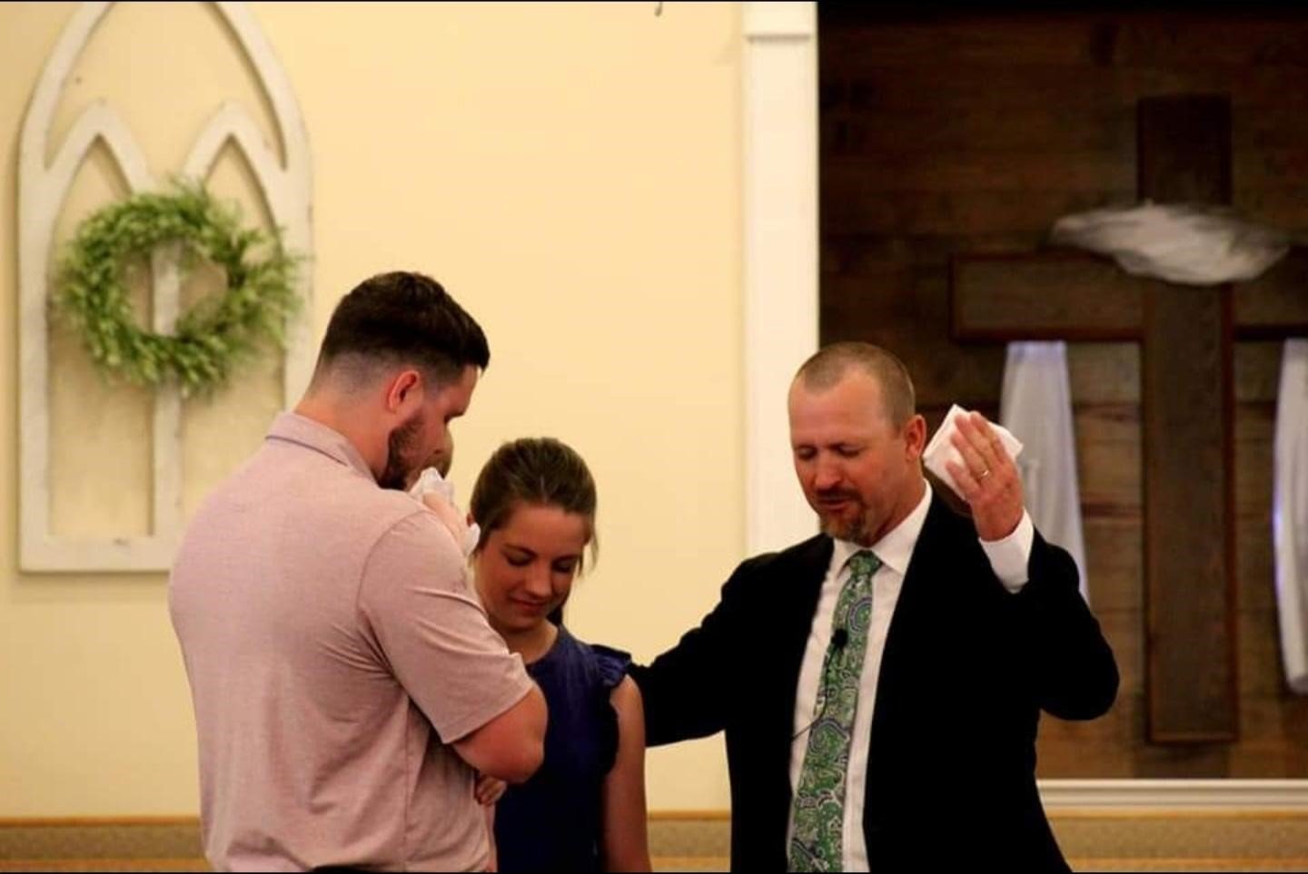 Pastor Kevin Geter, right, prays with new parents during a baby dedication at Ephesus Baptist Church in Ephesus, Ga. The congregation is growing in every way, including, in this case, with a new birth.