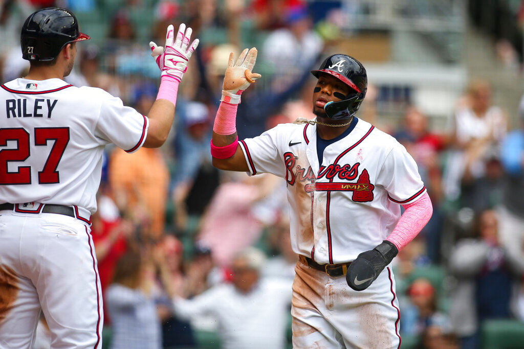 Atlanta Braves right fielder Ronald Acuna Jr., right, celebrates after scoring with third baseman Austin Riley (27) in the second inning of a baseball game against the Milwaukee Brewers, Sunday, May 8, 2022, in Atlanta. (AP Photo/Brett Davis)