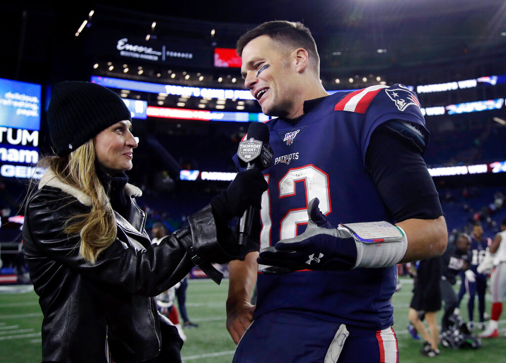 Fox Sports television sideline broadcast reporter Erin Andrews, left, interviews then-New England Patriots quarterback Tom Brady at midfield after an NFL football game between the Patriots and the New York Giants, Thursday, Oct. 10, 2019, in Foxborough, Mass. The seven-time Super Bowl champion will join Fox sports as its lead football analyst once his playing career ends, the network said on Tuesday, May 10, 2022. When that actually happens is unclear, since Brady recently renounced his announced retirement and said he plans to continue playing for the Tampa Bay Bucs. (AP Photo/Elise Amendola, File)