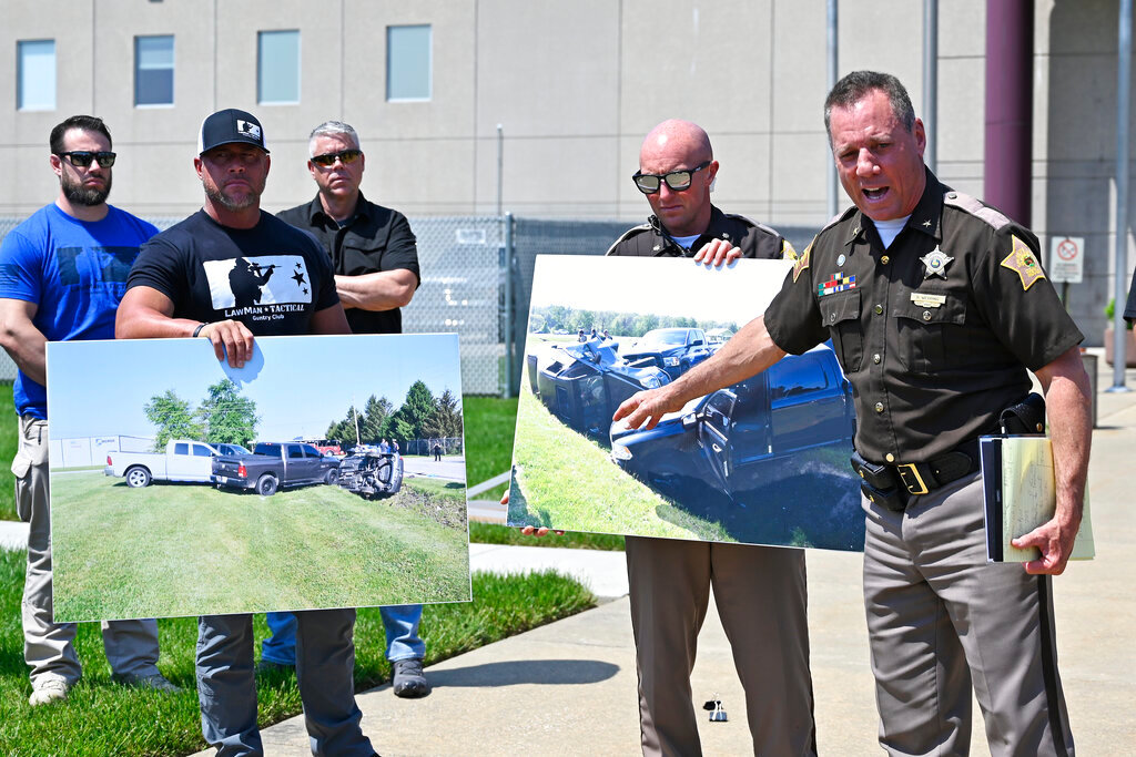 Vandenburgh County Sheriff Dave Wedding, right, refers to a photograph during a press conference in Evansville, In., Tuesday, May 10, 2022, about the capture of fugitives Casey White and Vicky White. (AP Photo/Timothy D. Easley)